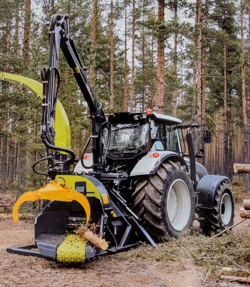 Europe Forestry DC 385 tractor-mounted in forest with grapple arm