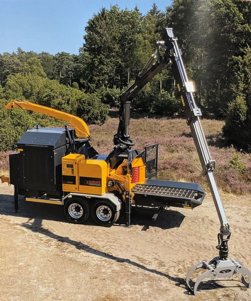 Europe Forestry EC 1060 drum chipper with crane extended outdoors