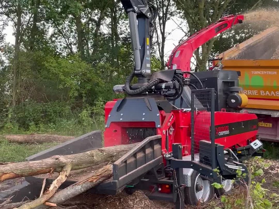 EC 850 track chipper with crane in forest setting